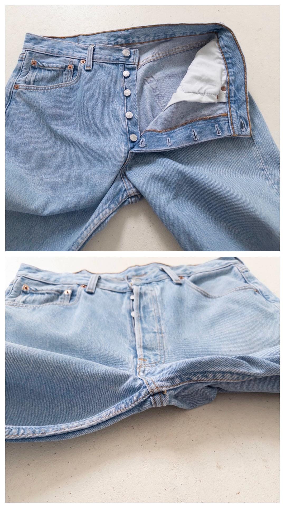 Detailaufnahme der Front mit 5-Knopf-Leiste (Button Fly) der Vintage Levi's 501 Jeans. Zeigt den Bund, die Nieten und den ausgewaschenen Denim-Stoff.